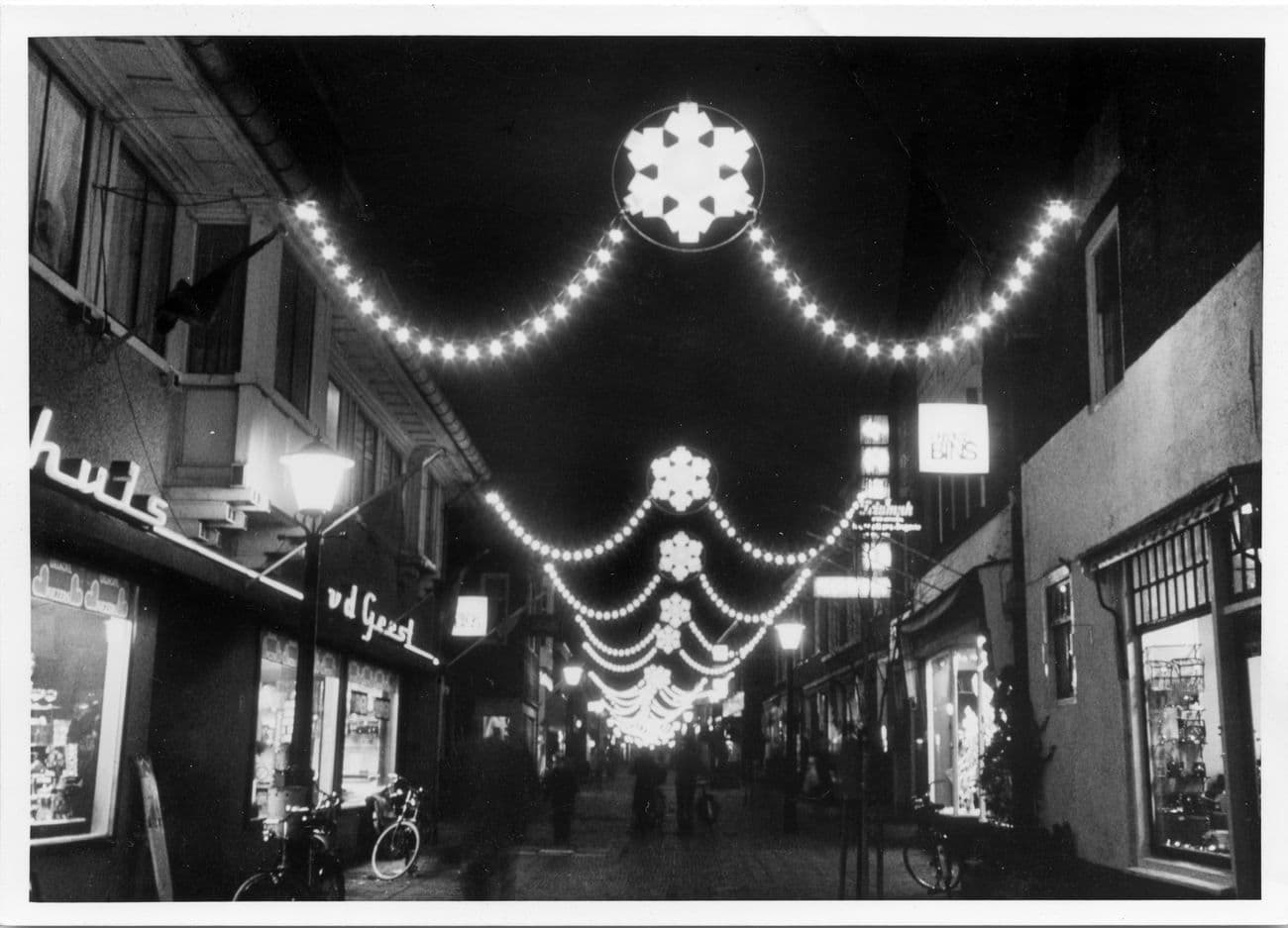 Festive lighting with stars above a shopping street